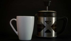 white mug with coffee brewer