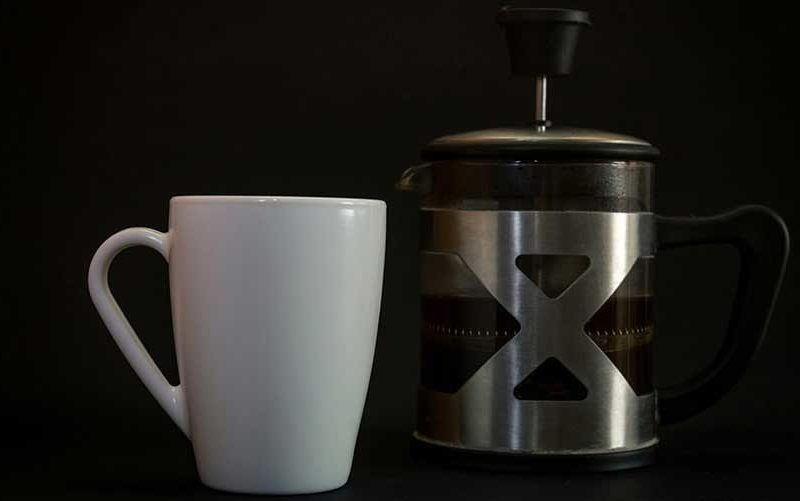 white-mug-with-a-french-press-min-800x501
