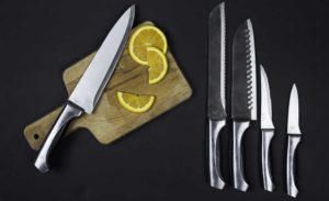 a knife set and a cutting board on a table