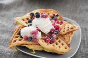 waffles with some berries & cream on them