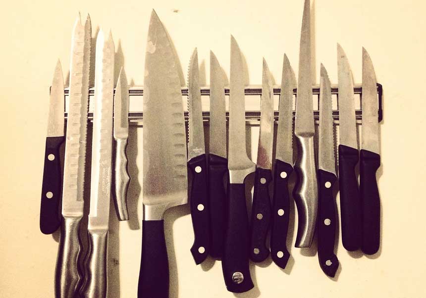 different knives on a wall knife stand