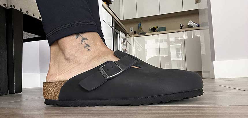 Close up of man wearing black colored Birkenstock chef shoes
