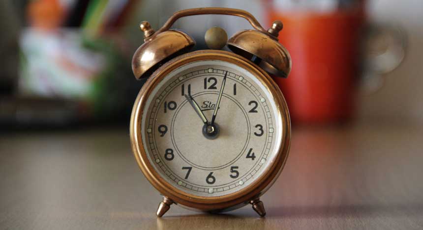 An analog timer on a kitchen shelf