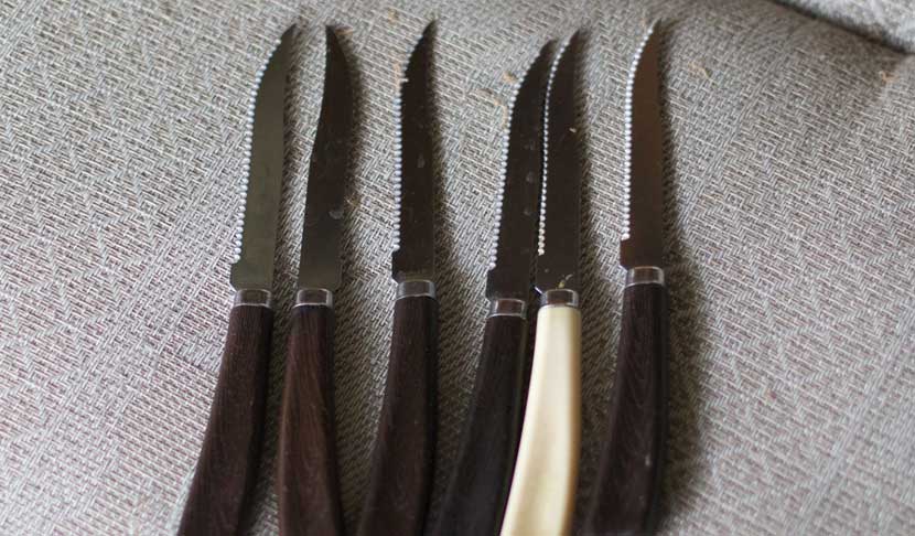 Different knives on a cloth in kitchen