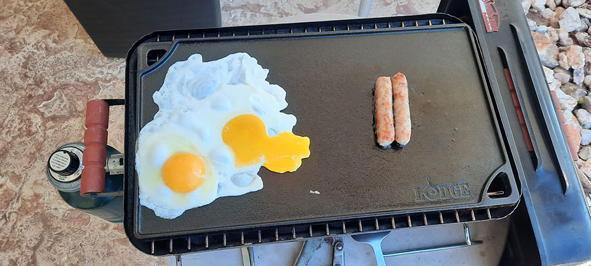 fried eggs & hot dog on lodge grill pan