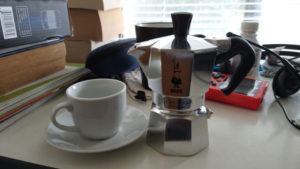 Bialetti Moka Pot on a table with a cup around