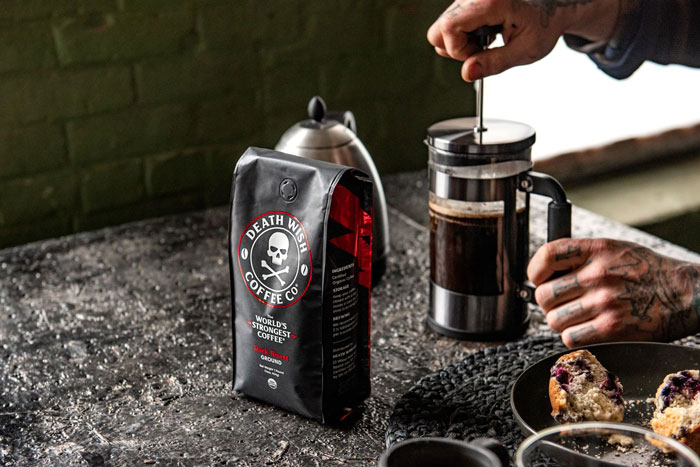 Man brewing coffee while Death Wish Coffee pack is around