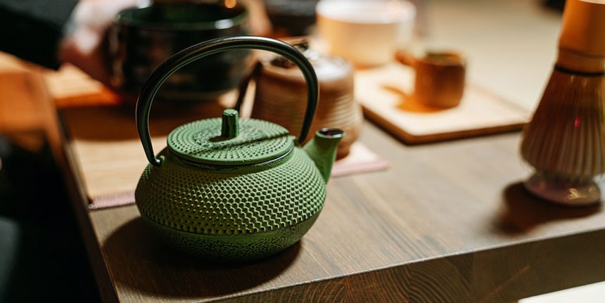 Close up of a cast iron tea kettle on a table